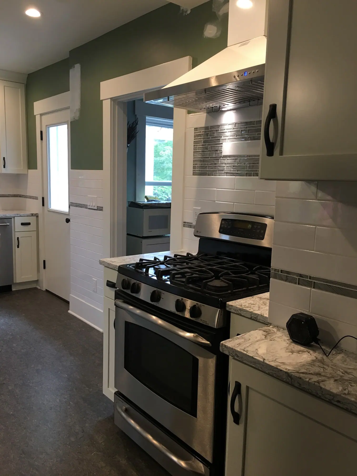 Kitchen with a gas range and green walls